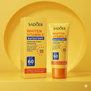 A yellow squeeze tube and display box for SADOER Whiten Vitamin C Sunscreen, featuring an SPF 60 PA+++ rating and Vitamin C branding against a vibrant yellow background.